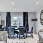 Elegant dining room with blue velvet chairs.