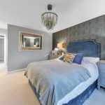 Modern bedroom with double bed and chandelier
