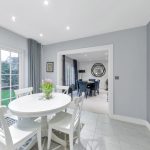 Bright dining room with table and garden view.