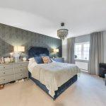 Modern bedroom with double bed and grey decor.