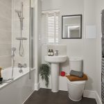 Modern bathroom with bath, shower, and towels.