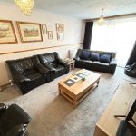 Cosy living room with leather sofas and decor.