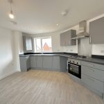 Modern kitchen with grey cabinets and tiled floor