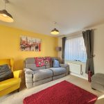 Cosy living room with yellow and grey decor.