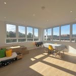 Bright room with windows and table.
