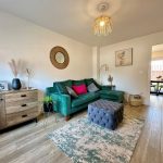 Modern living room with green sofa and decor