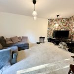 Modern living room with colourful feature wall.