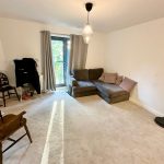 Cosy living room with sofa and wooden chair