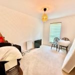 Spare room with chairs, mattress, and boxes.