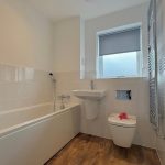 Modern bathroom with bathtub and wooden floor
