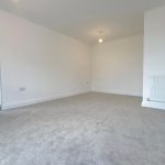 Empty room with carpet and radiator.
