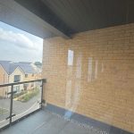 Sunny balcony view of modern houses.