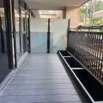 Modern balcony with glass railing and planters