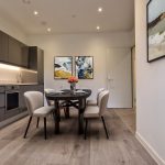 Modern kitchen dining area with artwork.