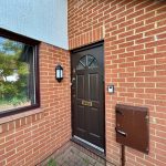 Brick house exterior with brown door and window
