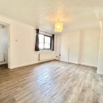 Bright empty room with wooden flooring