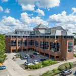 Modern brick office building on sunny day.