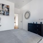 Modern bedroom with stylish decor and furniture.
