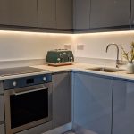 Modern kitchen with grey cabinets and toaster.