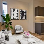 Modern living room with artwork and plants.