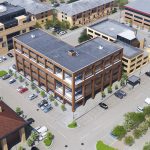 Aerial view of urban office buildings and car park.