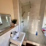 Modern bathroom with glass shower enclosure.