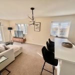 Modern living room with sofa and dining area.