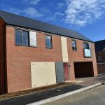 Modern brick house under clear blue sky.