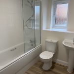 Modern bathroom with bath, shower, toilet, and basin.