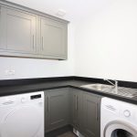 Modern utility room with washer and dryer units.