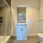 Modern bathroom with shower and sink.