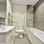 Modern bathroom with bathtub, shower, and sink