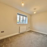 Empty room with carpet and window view.