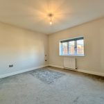 Empty room with grey carpet and window