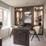 Modern home office with desk and art decor.
