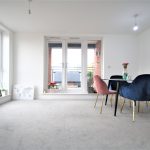 Modern dining area with large windows and chairs