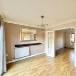 Bright living room with wooden floor and mirror