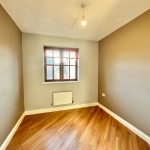 Empty room with wooden flooring and window