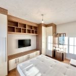 Modern bedroom with fitted wardrobe and TV