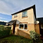 Two-storey brick house with satellite dish.