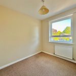 Empty room with beige walls and window view