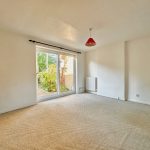 Empty bright living room with garden view.