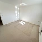 Empty room with carpet and radiator