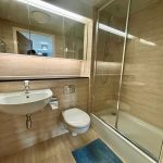 Modern bathroom with shower, sink, and toilet
