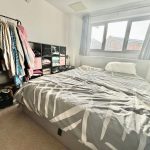 Bedroom with double bed and clothes rack