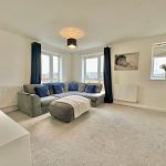 Bright living room with grey sofa and cushions.