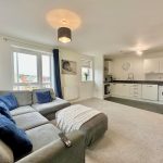 Modern open-plan living room and kitchen.