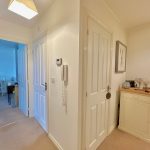 Cosy hallway with decorative elephant and wall art.
