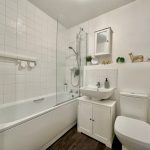 Modern white bathroom with bathtub and shower.