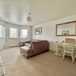 Cosy living room with sofa and dining table.